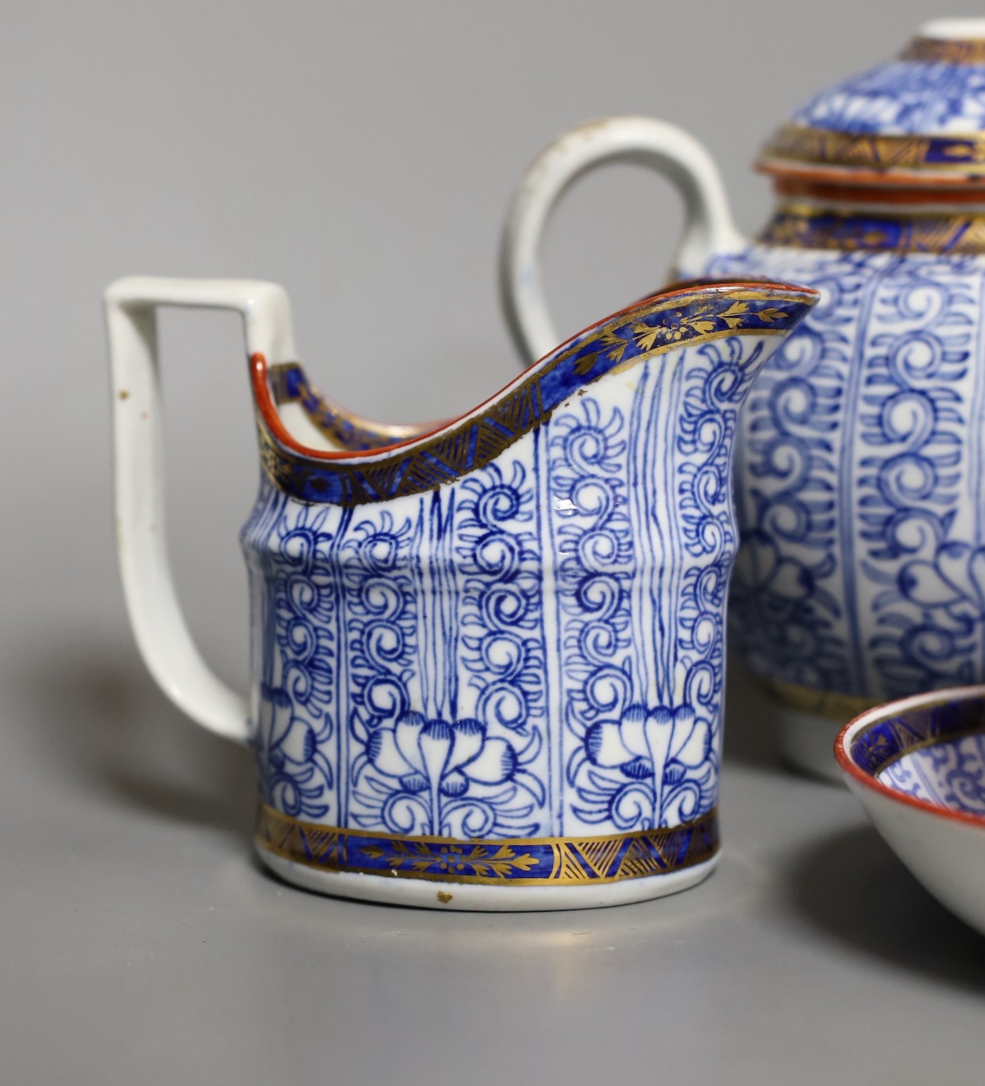 Two Worcester Royal Lily cups and saucers, a cream jug and a teapot- 18 cms high including lid